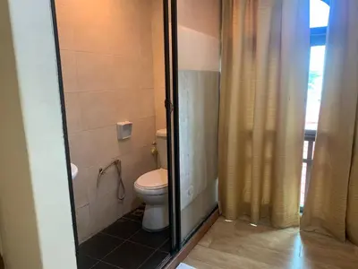 a bathroom with a toilet and a shower at D'Feringghi Hotel in Batu Ferringhi