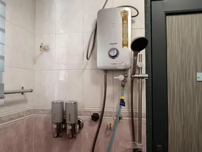 a shower in a bathroom with a machine on the wall at Grey Fantasy Homes#Sunway Water Theme Park in Ipoh