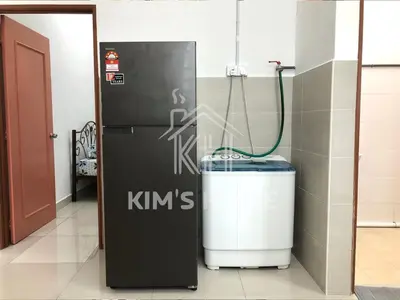 a room with a heater and a refrigerator in a room at Kim’s Home - Homey At Your Stay in Nibung Tebal