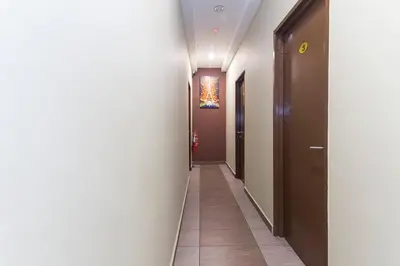 a hallway with white walls and a long corridor at Silibin Times Inn Hotel in Ipoh