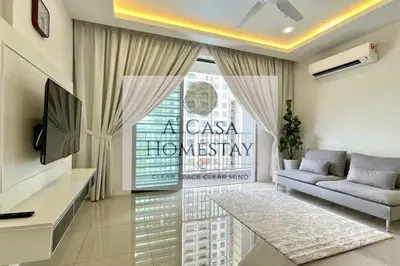 a living room with a couch and a tv at A' Casa Homestay Ipoh Perak in Ipoh