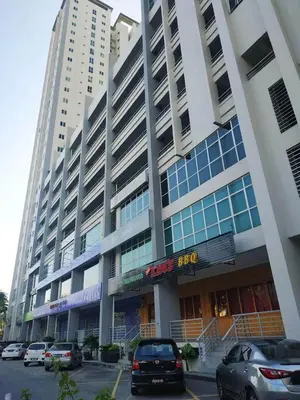 a large building with cars parked in front of it at Straits Garden Suites by Yen's Sojourn in George Town