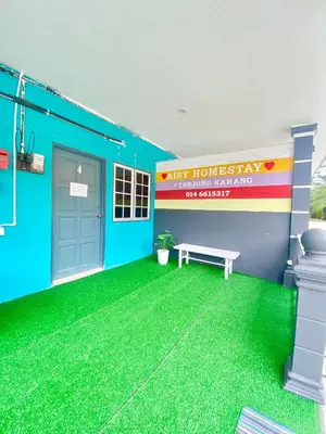 a blue building with a bench in front of it at AISY HOMESTAY - Rumah 4 atau 5 in Kampong Tanjong Karang