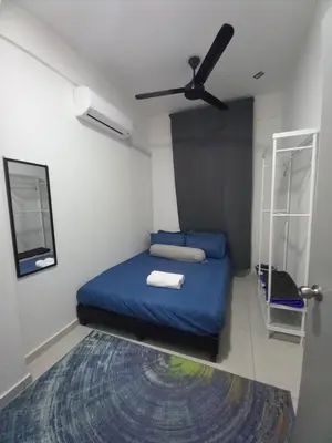 a bedroom with a blue bed and a ceiling fan at SAFIYYA HOMES MERU RAYA - WIFI/NETFLIX in Ipoh