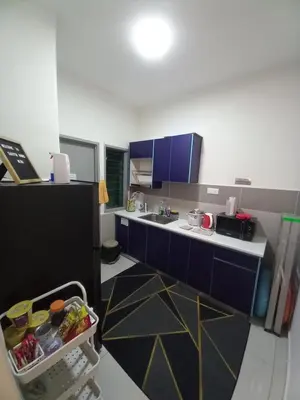 a small kitchen with blue cabinets and a sink at SAFIYYA HOMES MERU RAYA - WIFI/NETFLIX in Ipoh