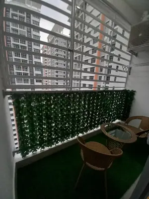 a balcony with chairs and a window with green plants at SAFIYYA HOMES MERU RAYA - WIFI/NETFLIX in Ipoh