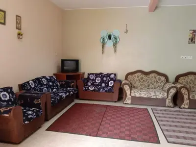 a living room with several couches and a tv at Sobey Laris Homestay CHIKU1 in Gua Musang