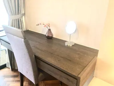 a wooden table with a vase of flowers on it at Seaview Water Purify Cozy Comfortable for Short & Long Stay in The Landmark by Katana in George Town