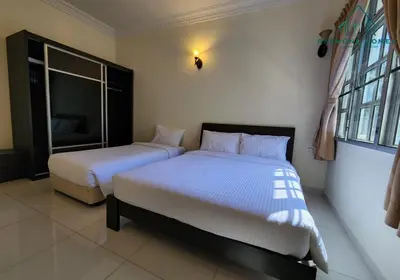 a bedroom with two beds and a window at 99 Kelawei in George Town
