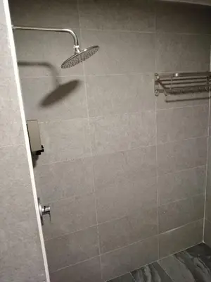 a shower with a shower head in a bathroom at Copthorn Homestay in Brinchang