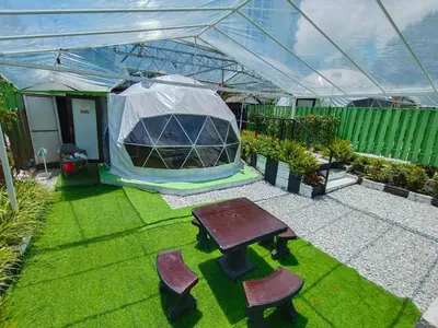 a tent with a table and chairs in a yard at Glamz Hills in Cameron Highlands