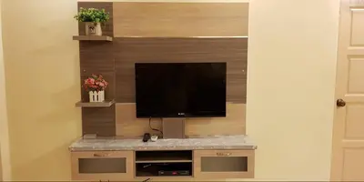 a entertainment center with a flat screen tv on a wall at Crown Imperial Court Apartment (Madam Ng)1 in Cameron Highlands