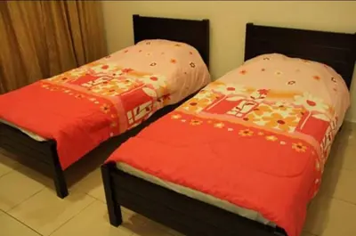two beds sitting next to each other in a room at Crown Imperial Court Apartment (Madam Ng)1 in Cameron Highlands