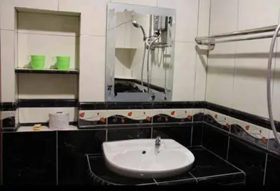 a black and white bathroom with a sink and a mirror at Crown Imperial Court Apartment (Madam Ng)1 in Cameron Highlands
