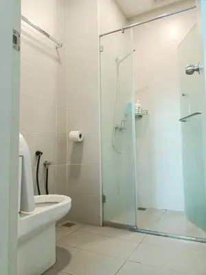 a bathroom with a toilet and a glass shower at Deluxe Suites Stay, Netflix,2BR, in George Town