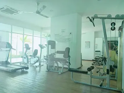 a gym with several treadmills and exercise bikes at Deluxe Suites Stay, Netflix,2BR, in George Town