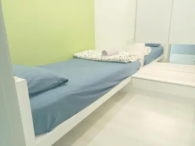 a bed with blue sheets and pillows in a room at Deluxe Suites Stay, Netflix,2BR, in George Town
