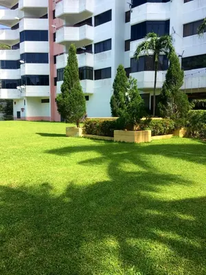 a large lawn in front of a building at Happy Home 10 Sri Sayang Batu Ferringhi in Batu Ferringhi