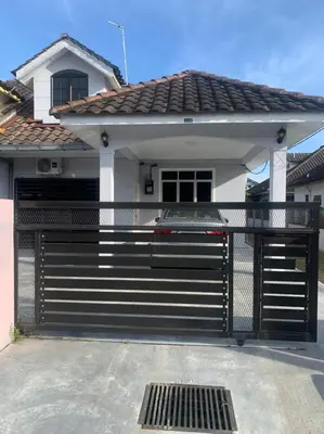 a black gate in front of a house at Homestay Maryam in Lumut
