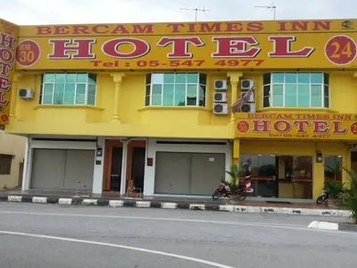 a yellow building with a sign on the side of it at Bercam Times Inn Hotel in Ipoh
