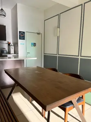 a dining room with a wooden table and chairs at Fazlia Resthouse at Golden Hills Cameron Highlands near pasar malam in Tanah Rata