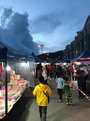 a group of people walking through a market at night at Fazlia Resthouse at Golden Hills Cameron Highlands near pasar malam in Tanah Rata