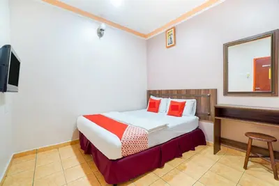 a hotel room with a bed and a desk at Hill Times Inn Hotel in Ipoh