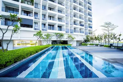 a swimming pool in front of a building at \u7687\u5bb6\u6d77\u666fROYAL Luxury Seaview Room, 3 minute to Gurney in Tanjong Tokong
