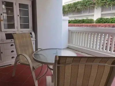 a glass table and a chair on a balcony at WOW Strait Quay Luxury Suite Room in Tanjong Tokong