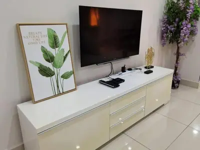 a white entertainment center with a flat screen tv at SUMMERSET 8PAX 3BR LUXURY SEAVIEW SUITE ROOM in George Town