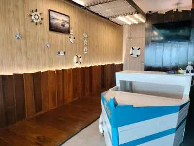 a room with wooden walls and a counter with boxes at Sekinchan PaddyCruise Homestay Wifi in Sekincan
