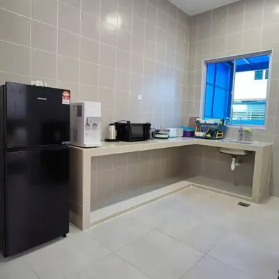 a kitchen with a black refrigerator and a counter at W39WarmStay@GoldenHills/NightMarket/4R/BBQ in Brinchang