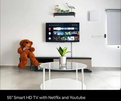 a teddy bear sitting on a chair in a living room at New 2 storey-Majestic Homestay 3 min to Night Market in Brinchang