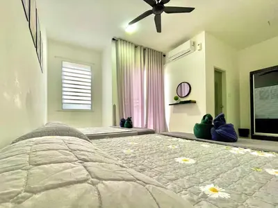 a bedroom with a bed and a ceiling fan at Hanan Homestay Klebang Ipoh with a view of Mount Korbu, for Musl!m only!! in Ipoh
