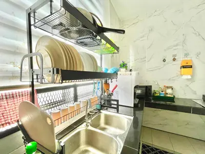a kitchen with a sink and a shelf above it at Hanan Homestay Klebang Ipoh with a view of Mount Korbu, for Musl!m only!! in Ipoh