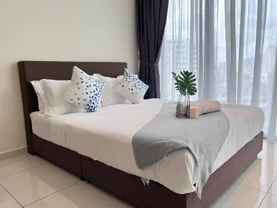a bed with pillows and a potted plant on it at Georgetown#Beacon Executive Suite SkyPool#Luxury&Glamorous Suite#2BR#Living Room with Queen Bed in George Town