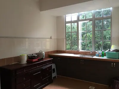 a kitchen with a sink and a counter and windows at Cameron Pasar Malam Apartment @ Crown Imperial Court in Cameron Highlands
