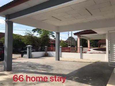 a white homestay with a porch and a driveway at 66 Semi-D Homestay in Teluk Intan