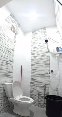 a bathroom with a toilet and a shower at Ainaz Homestay Balik Pulau in Balik Pulau