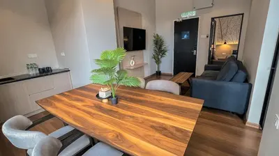 a living room with a wooden table and a couch at Hotel Brynton at Cameron Centrum Mall in Cameron Highlands