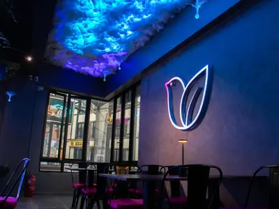 a restaurant with a neon sign on the side of a wall at Hotel Brynton at Cameron Centrum Mall in Cameron Highlands