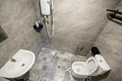 a bathroom with a toilet and a sink at De Luma Alma 9 bedroom with 8 bathroom in Bukit Mertajam