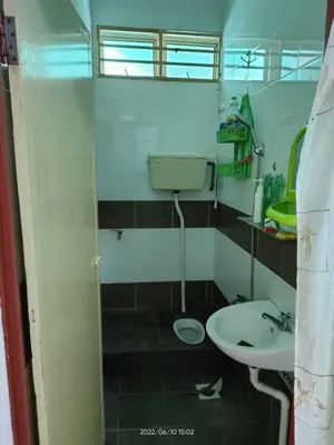 a small bathroom with a sink and a toilet at Rumah Singgah in Pantai Remis