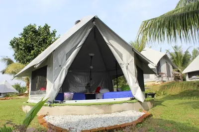 a black and white tent with blue beds in it at Fraser Valley Kuala Kubu Bharu in Kuala Kubu Baharu