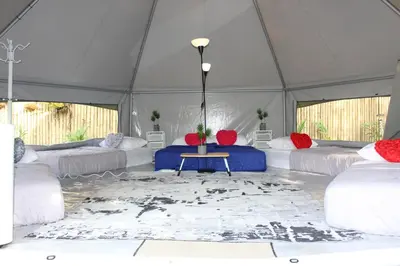 a tent with beds and a table in it at Fraser Valley Kuala Kubu Bharu in Kuala Kubu Baharu