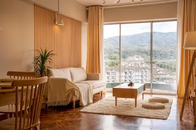 a living room with a couch and a table at Star Regency by Plush in Brinchang