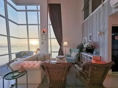 a living room with a couch and chairs at Maritime Suites Penang in Jelutong