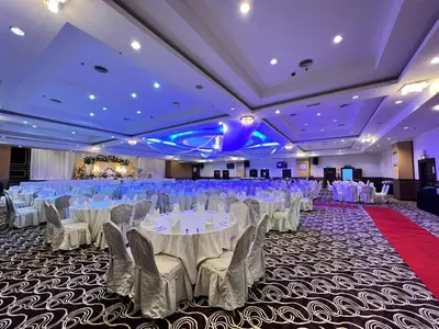a banquet hall with white tables and chairs at Hotel Taiping Perdana in Taiping