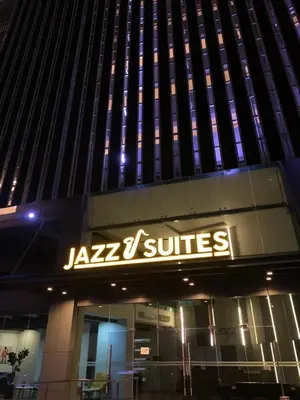 a jago suites sign on the side of a building at Jazz Service Suites 2 bedroom 35-1 by Yen's Sojourn in Bagan Jermal