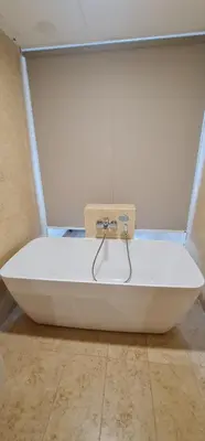 a white bath tub sitting on the floor in a room at Jazz Service Suites 2 Bedroom 23-3 by Yen's Sojourn in Bagan Jermal
